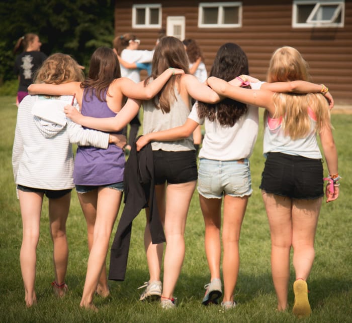 Girls walking with arms around each other