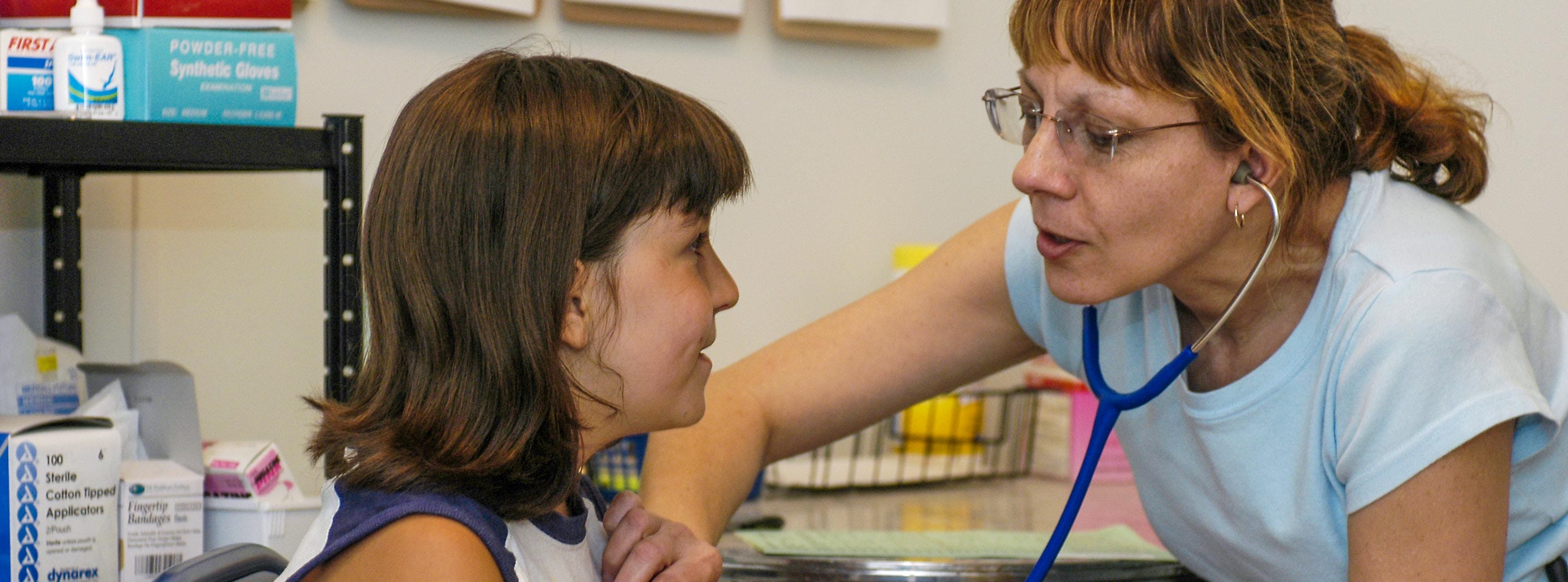 Nurse with camper in health center