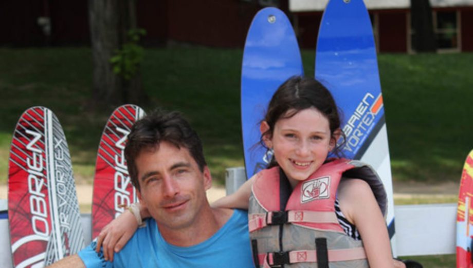 Father and daughter by waterskis at Family Camp