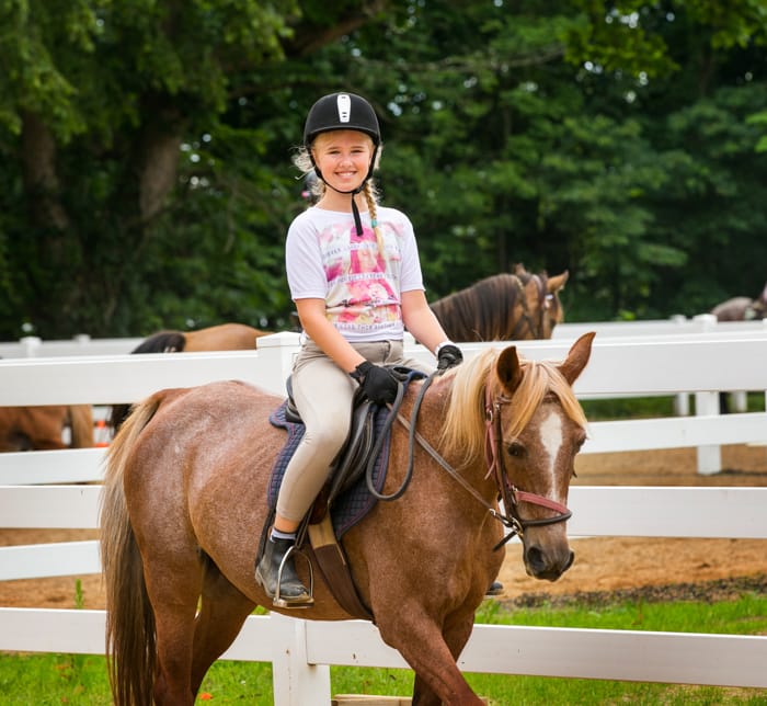 Camper riding horseback